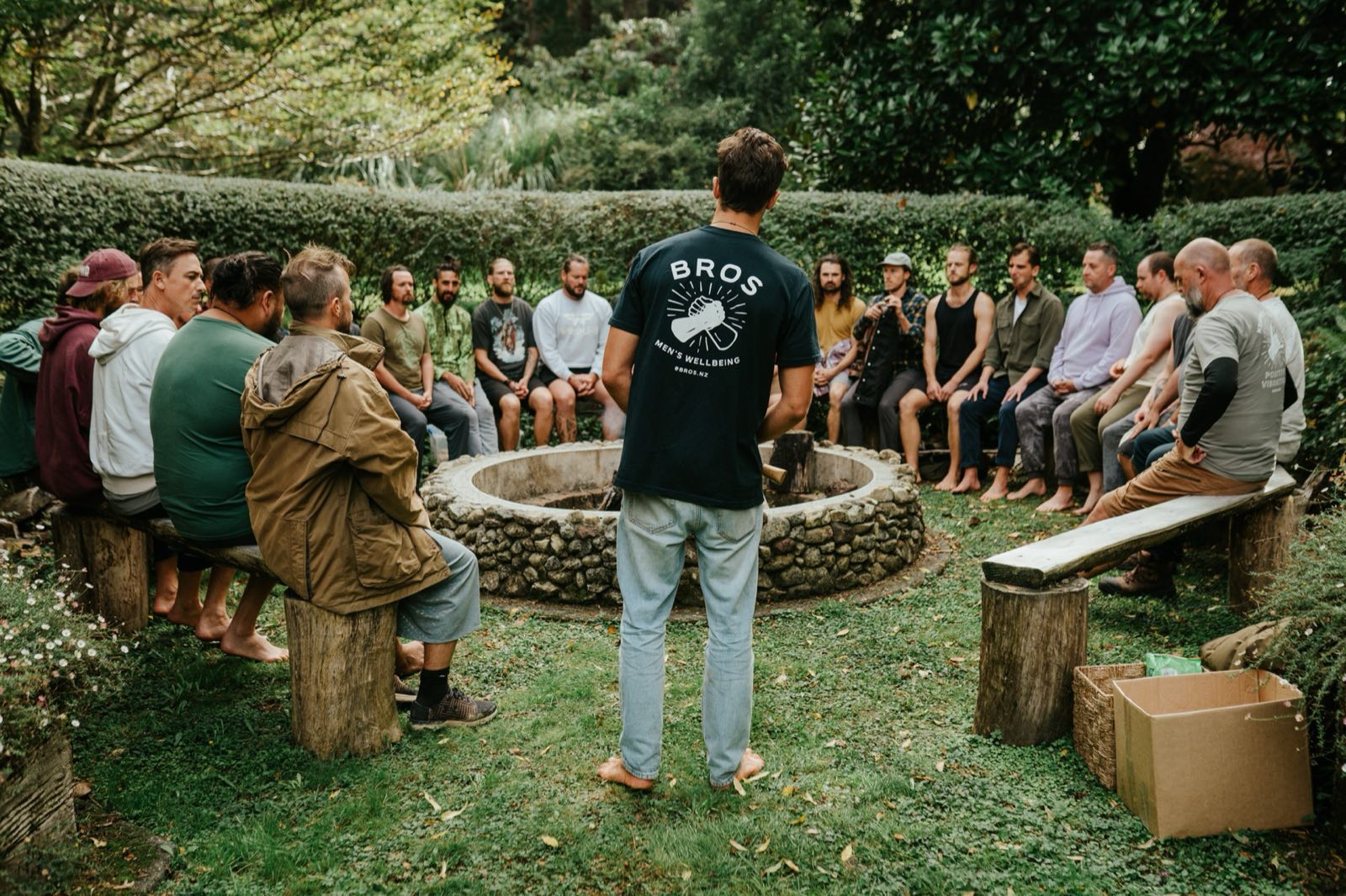 A men's circle around the stone firepit