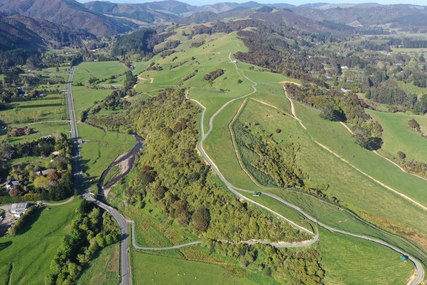 Aerial of the Mangaroa Valley — farm, river and ngāhere